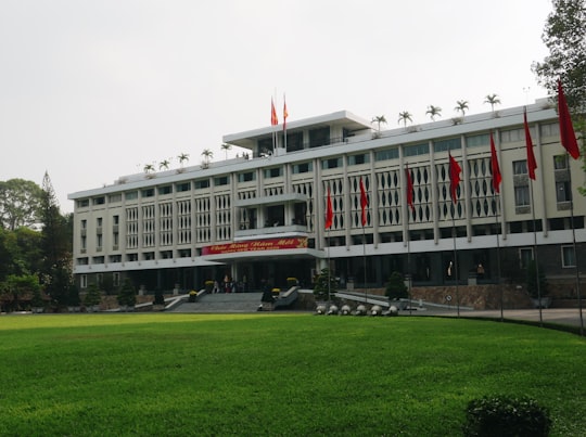 white and red concrete building in Independence Palace Vietnam