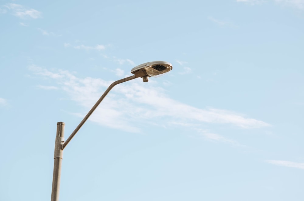 white and black street light under blue sky during daytime