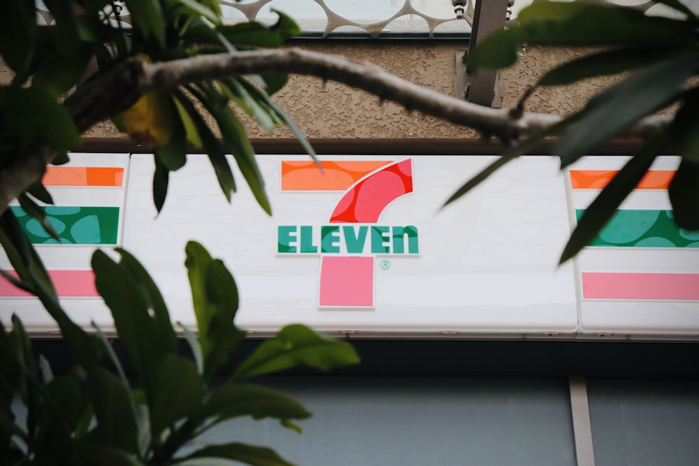 green and white signage on brown tree branch