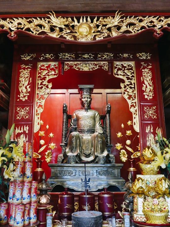 gold and red hindu deity statue in Temple Of Literature Vietnam
