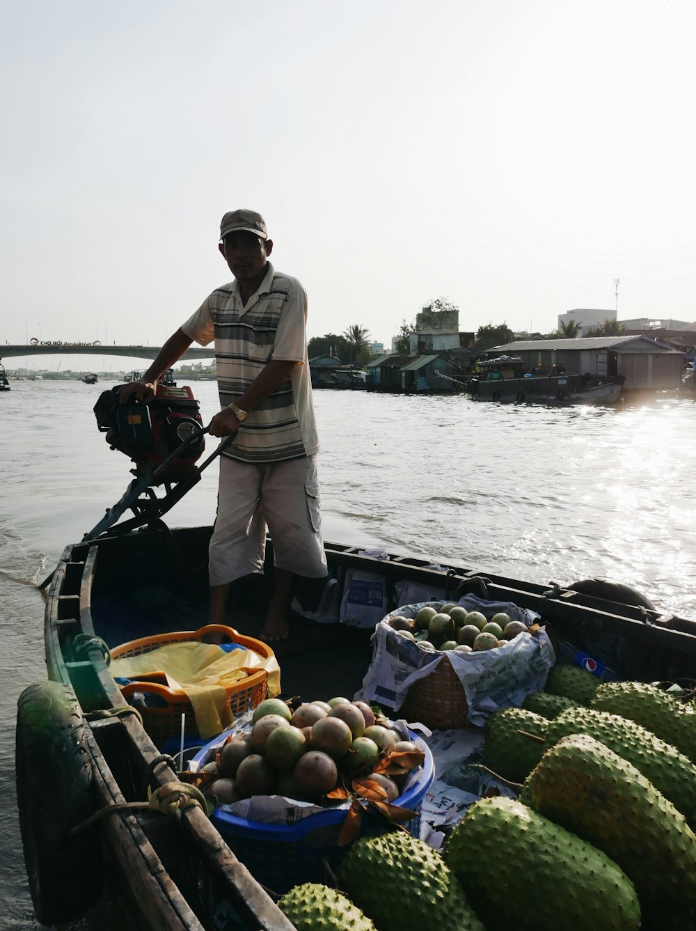 man in white shirt and black pants standing on boat during daytime