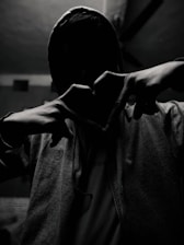 Close-up of a red heart emblem embroidered on a black hoodie, symbolizing passion and identity.