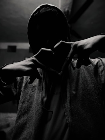Close-up of a red heart emblem embroidered on a black hoodie, symbolizing passion and identity.
