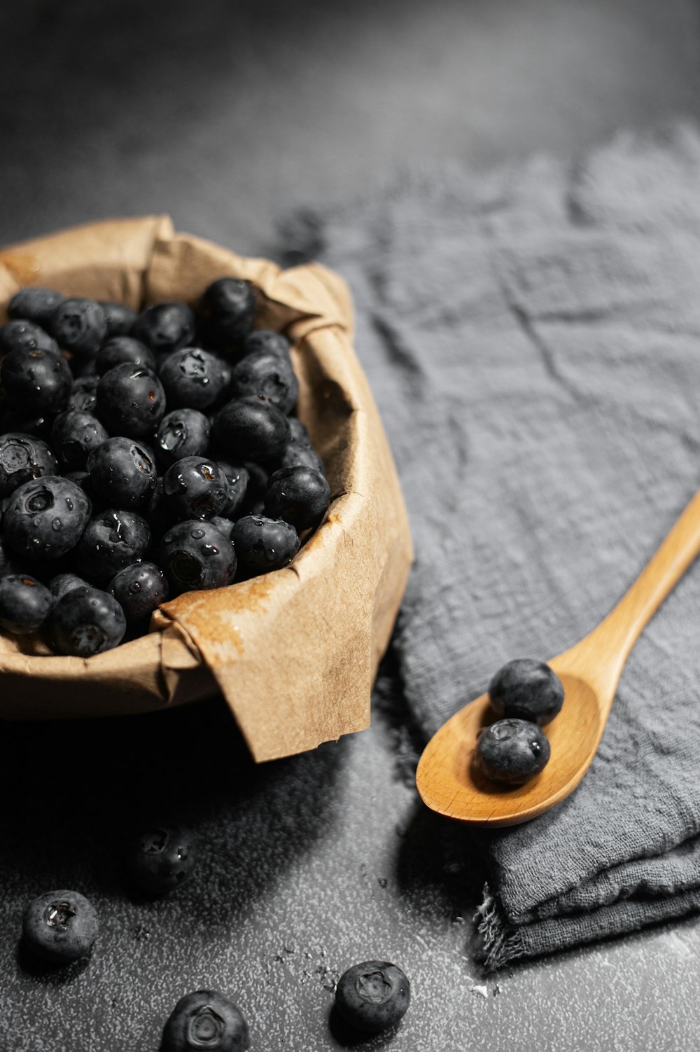 black berries on brown wooden spoon