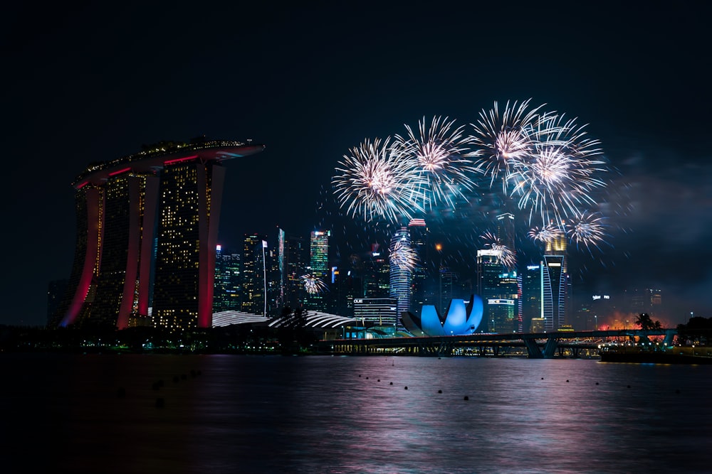fireworks display over the city during night time
