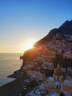 houses near body of water during sunset