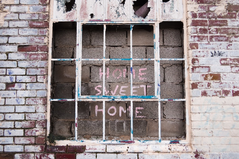 gray wooden door with red and white love text