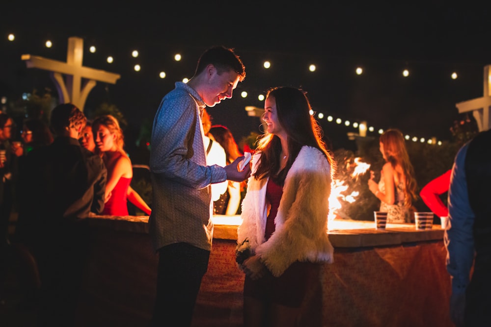 man in blue suit jacket and woman in white fur coat