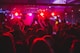 people standing on stage with lights turned on during nighttime