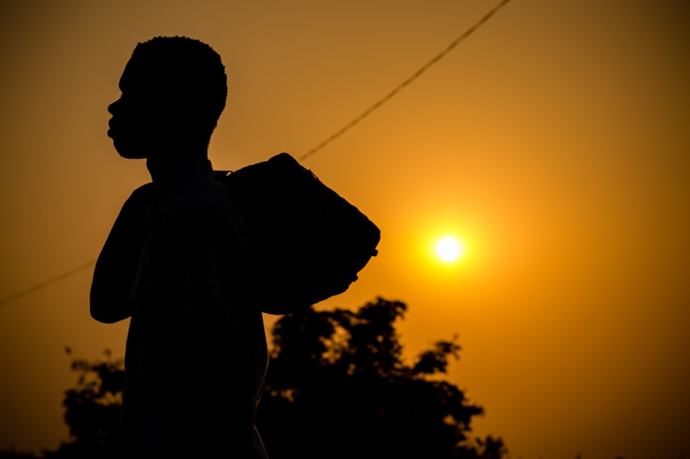 silhouette of man during sunset