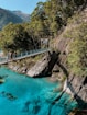 people walking on bridge over river during daytime