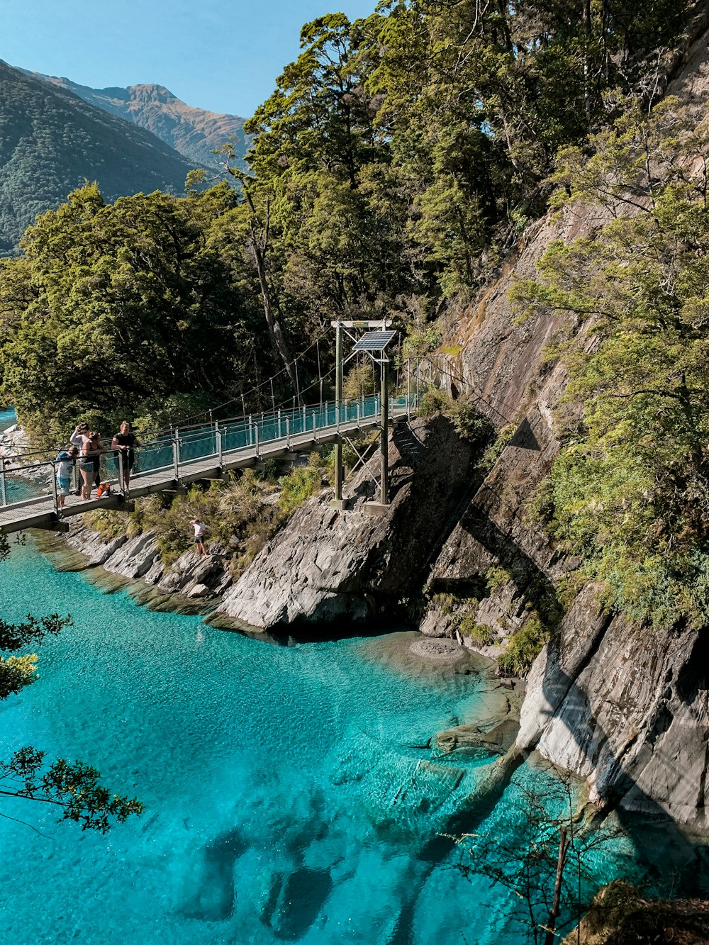 people walking on bridge over river during daytime