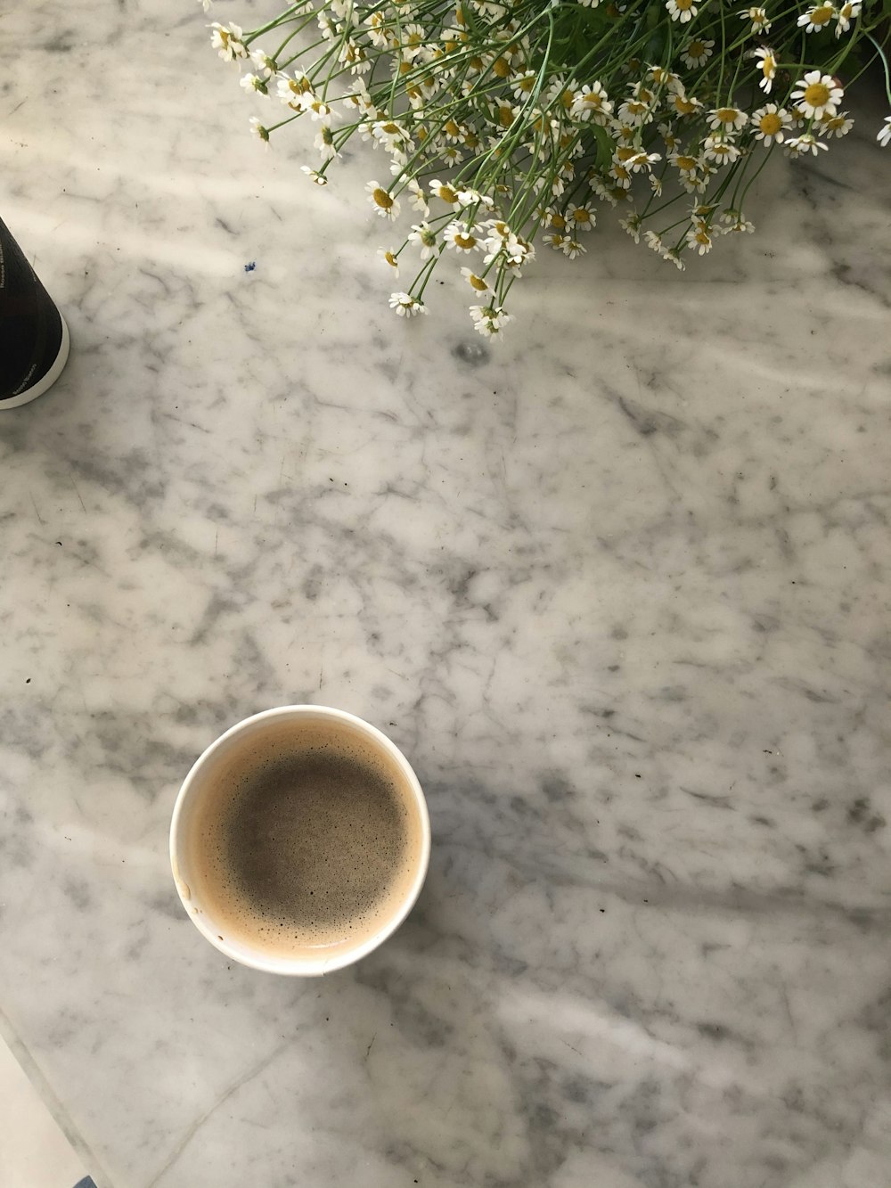 white ceramic mug with brown liquid