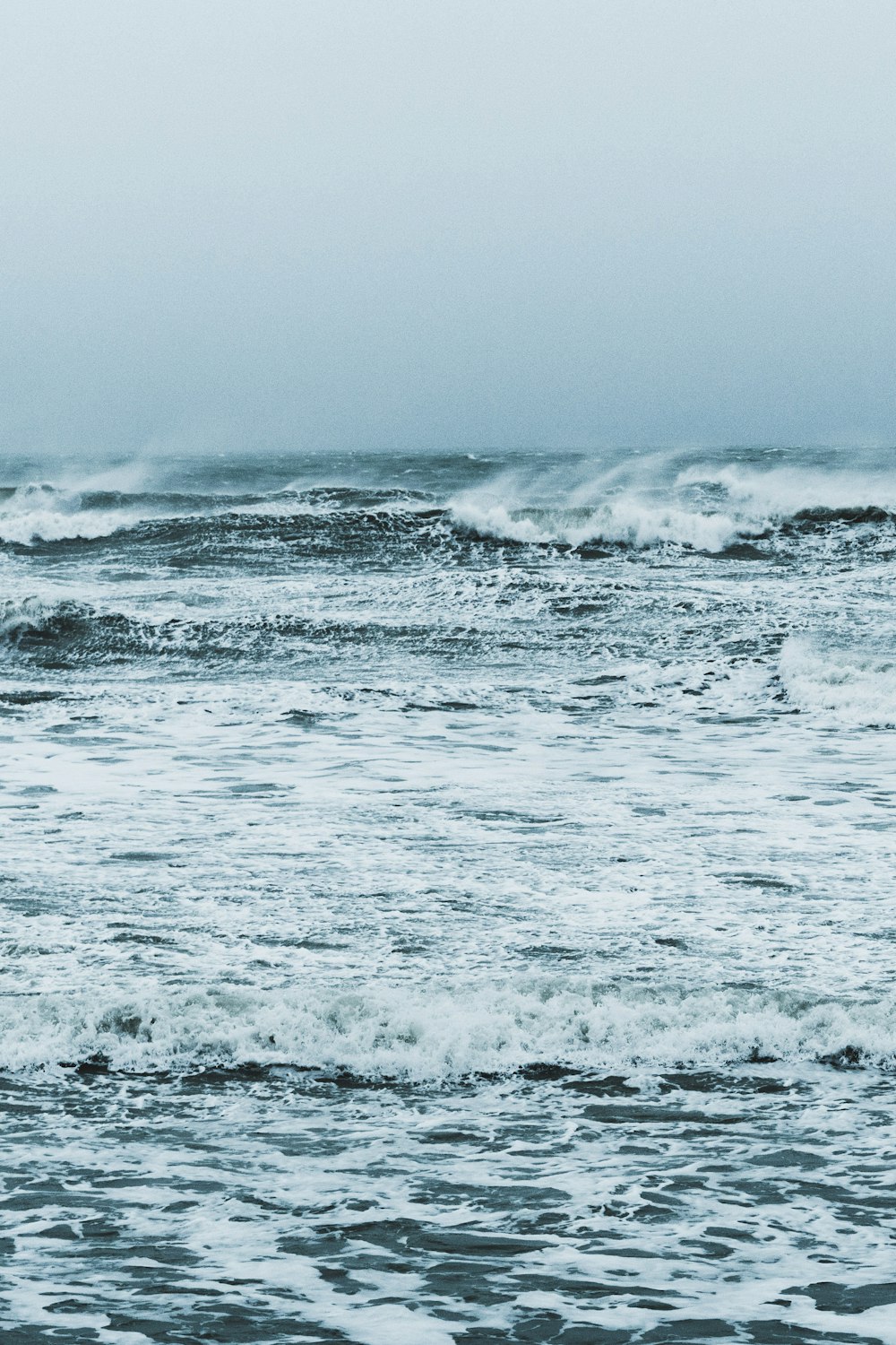 ocean waves crashing on shore during daytime