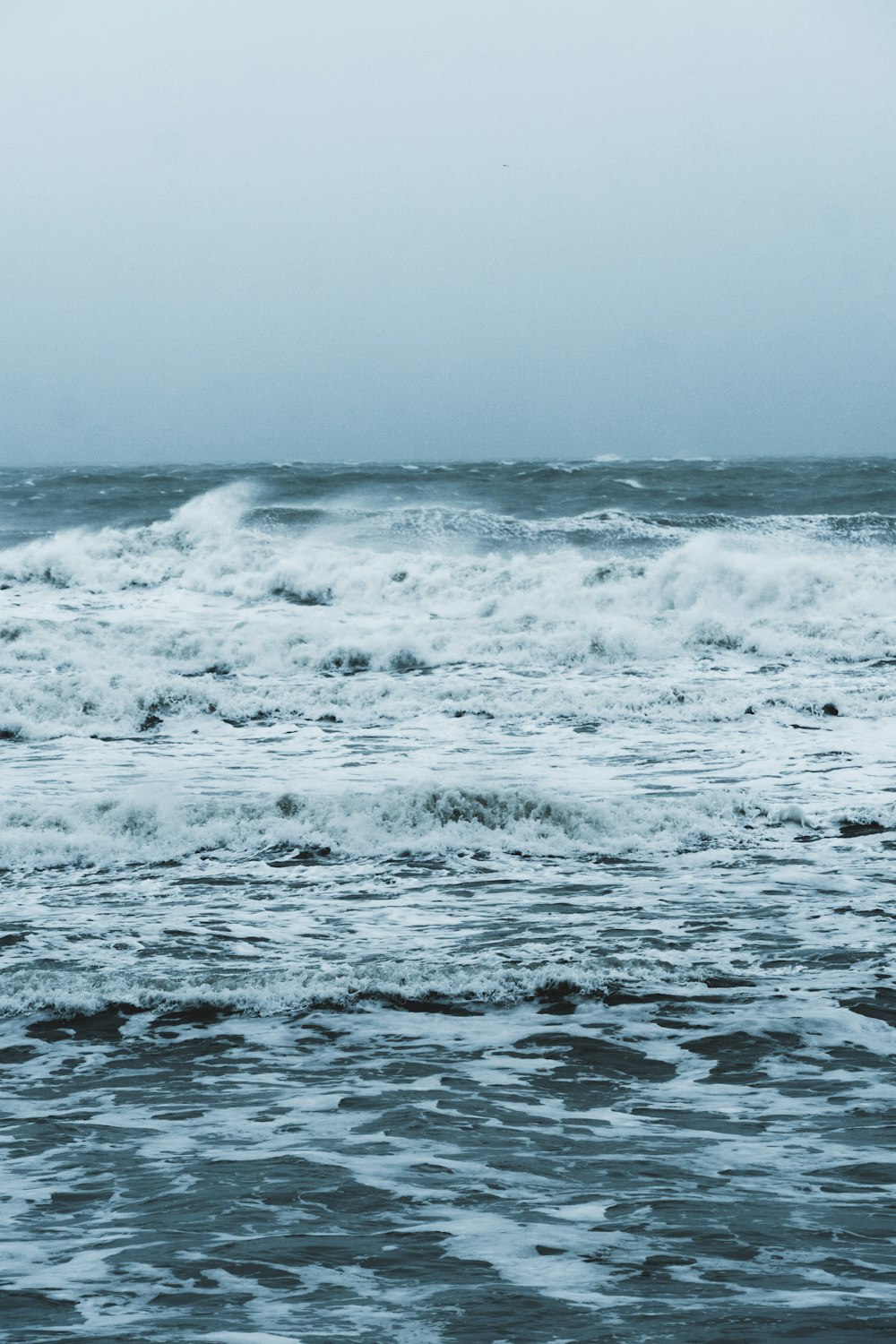 ocean waves crashing on shore during daytime