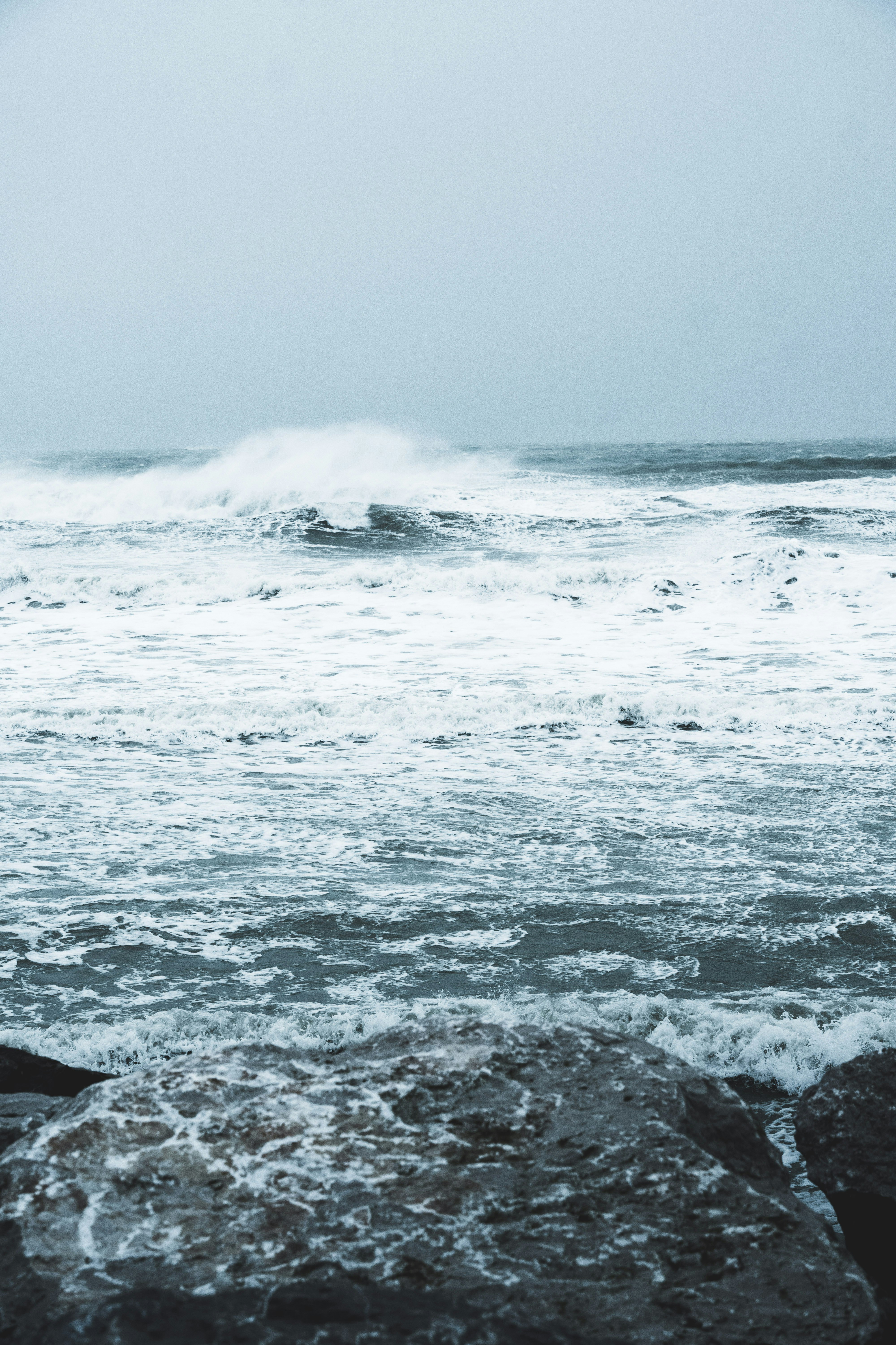 ocean waves crashing on shore during daytime