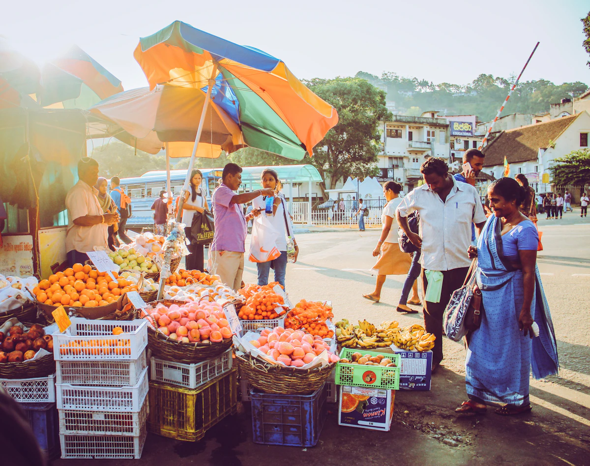 People and fruit stalls on a central street in Kandy