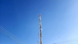 brown and white electric tower under blue sky during daytime