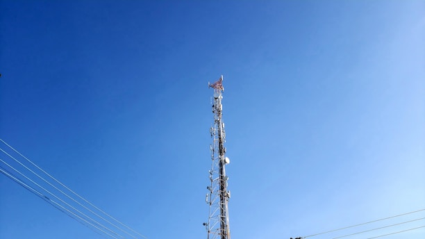 brown and white electric tower under blue sky during daytime
