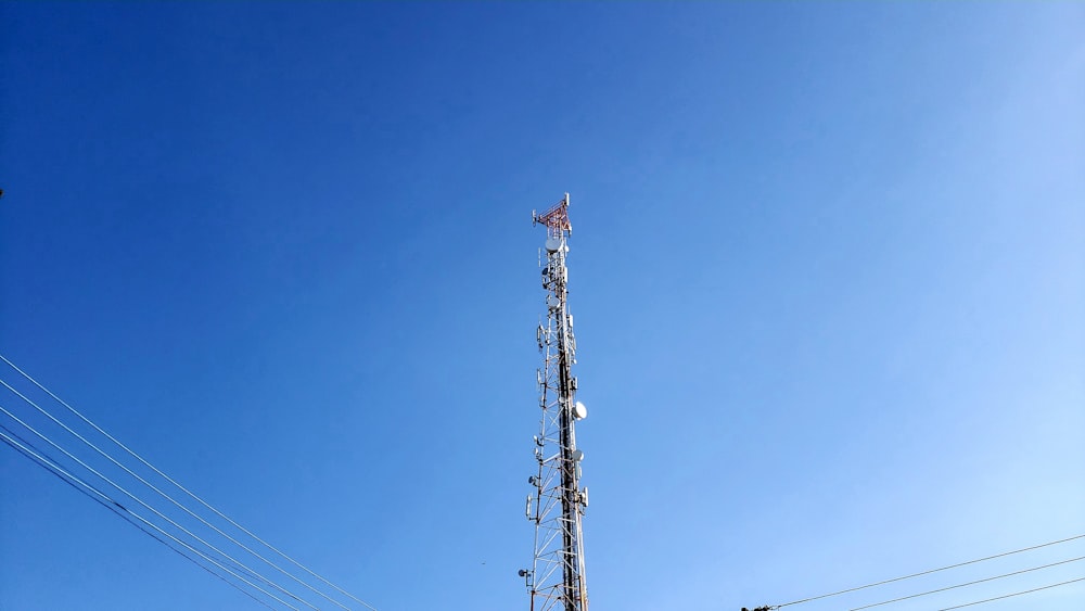 brown and white electric tower under blue sky during daytime