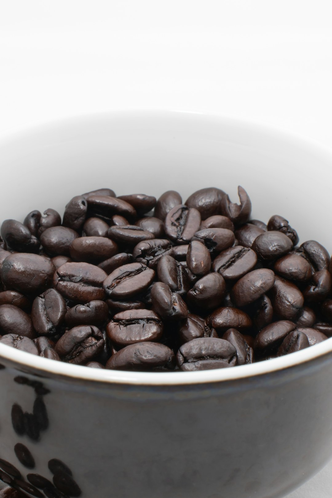 coffee beans in white ceramic mug