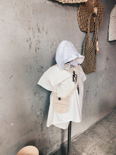 Elegant crochet outfit displayed on a wooden mannequin, highlighting the texture and craftsmanship of the yarn.