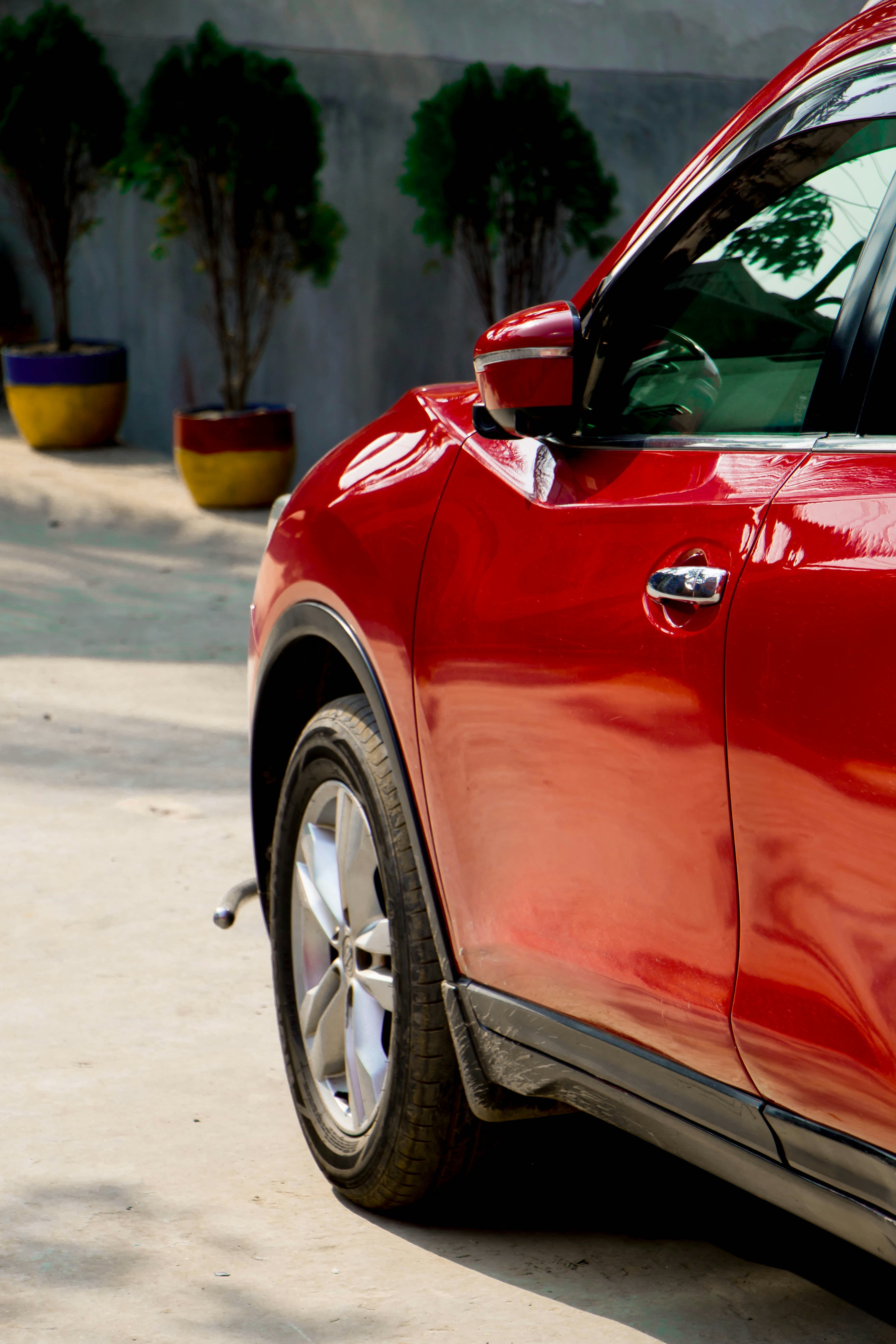 red car on gray asphalt road during daytime