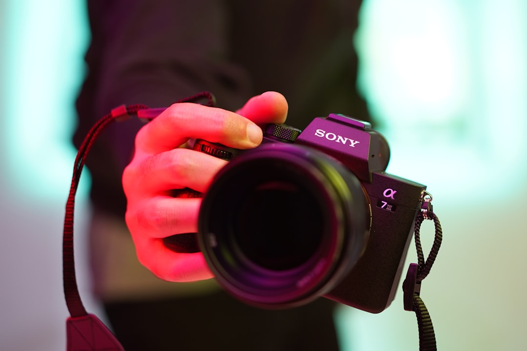 person holding black nikon dslr camera