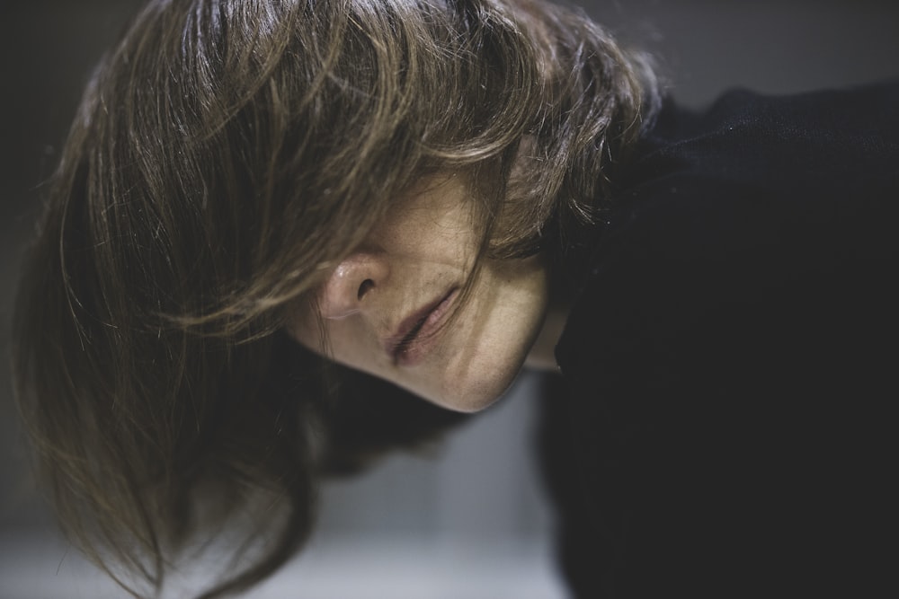 woman in black shirt looking down