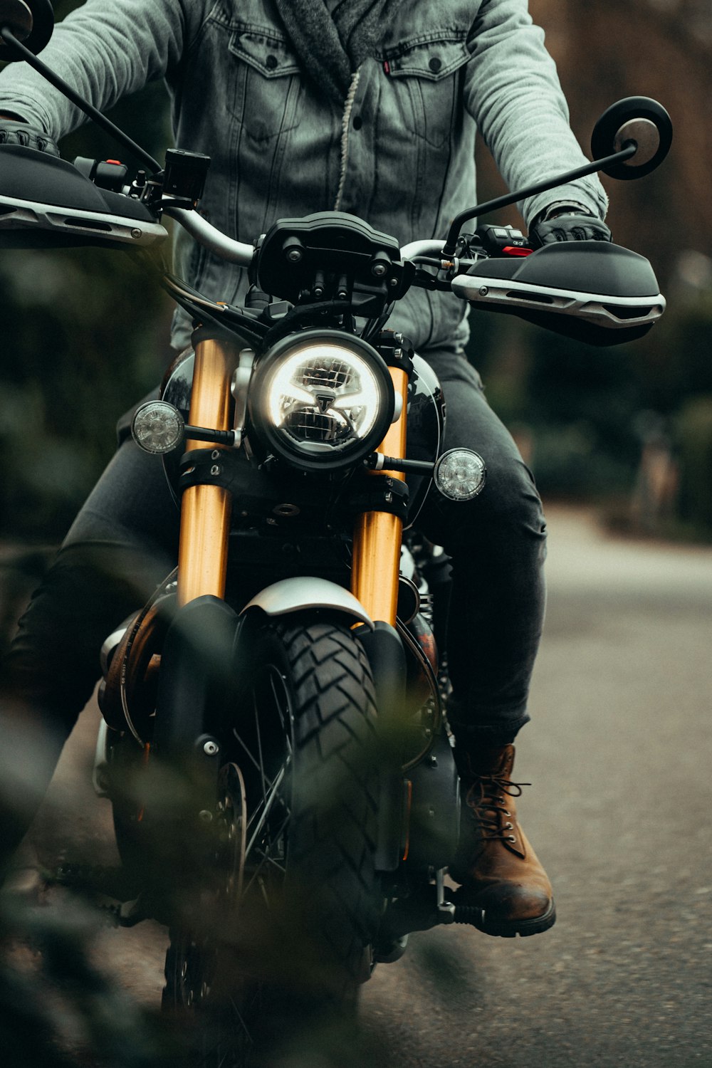 person in black leather jacket riding on black motorcycle