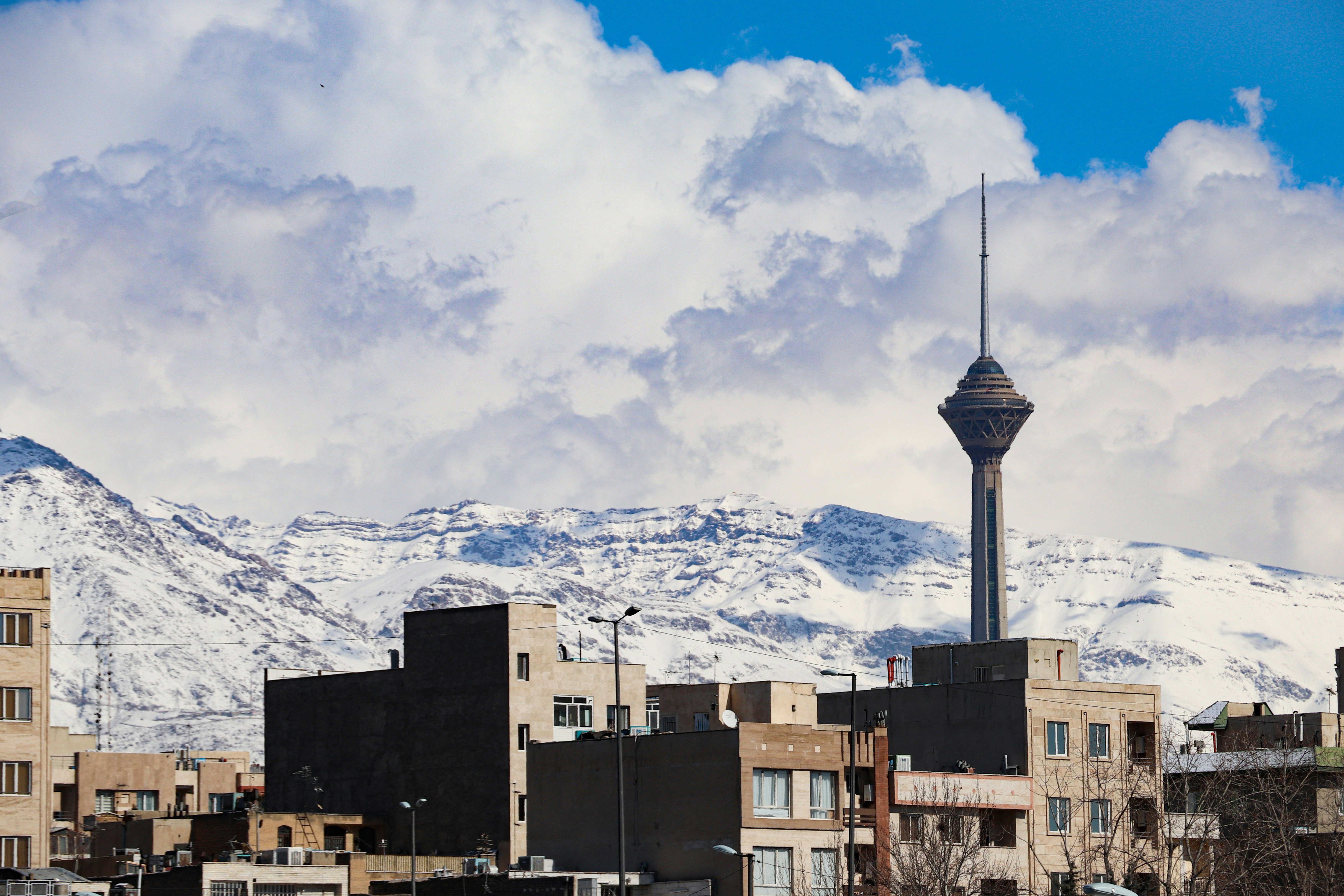 A landscape of Iranian capital Tehran in a cold, snowy weather, with a view of Milad tower. نمایی از برج میلاد تهران در یک روز برفی.