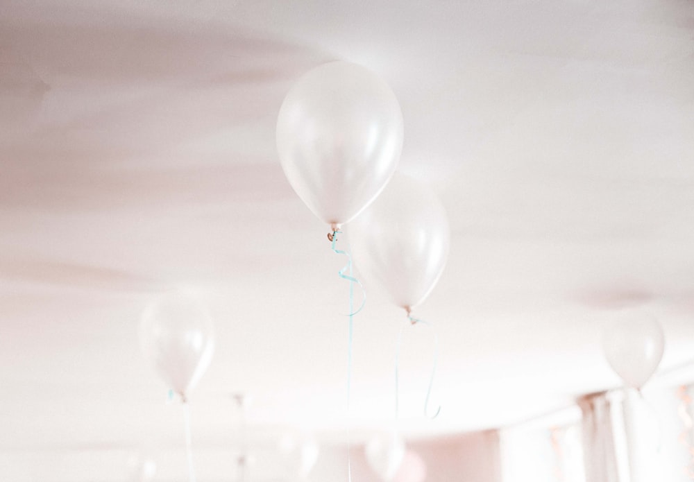 white balloons on white ceiling