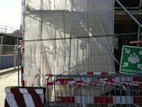 A blurred construction site with caution tape indicating work in progress.