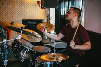 man in black crew neck t-shirt playing drum