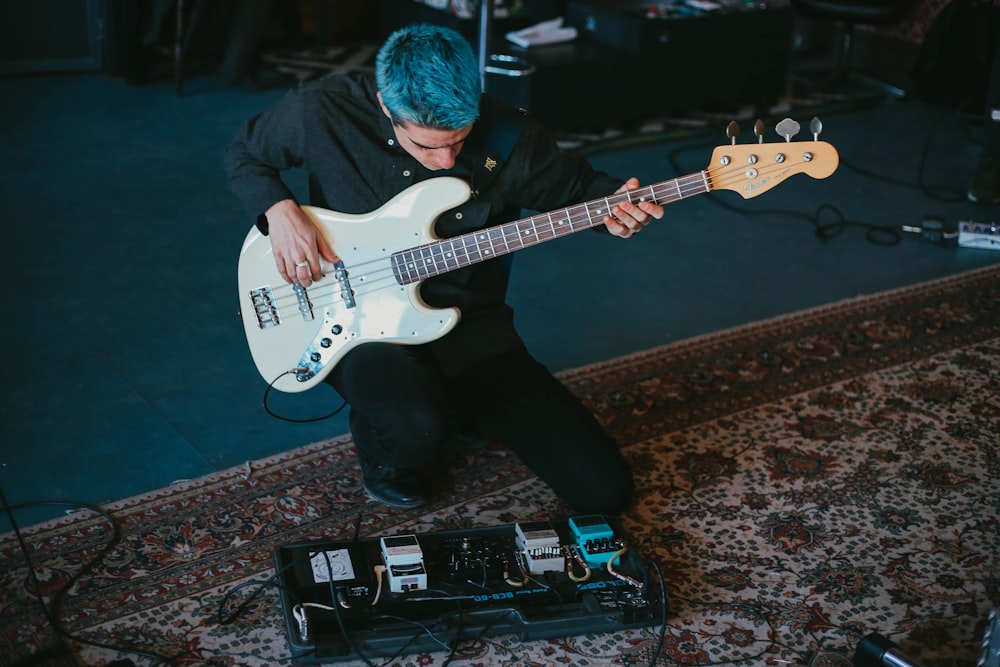 man in black jacket playing electric guitar