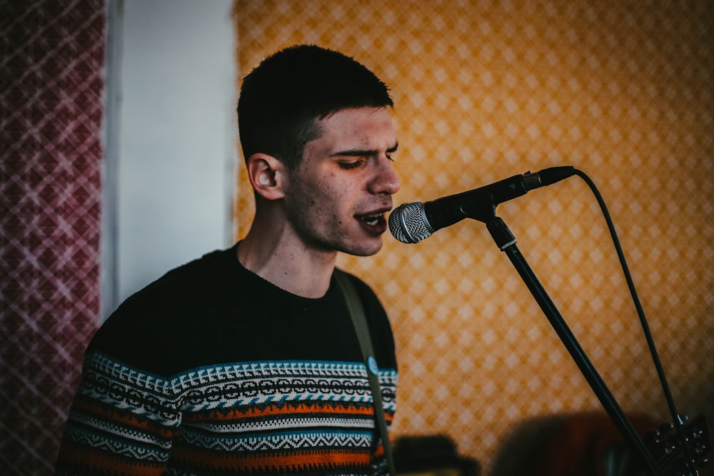 man in black crew neck shirt singing