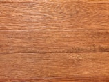 Detailed texture of restored wood grain with warm brown tones.