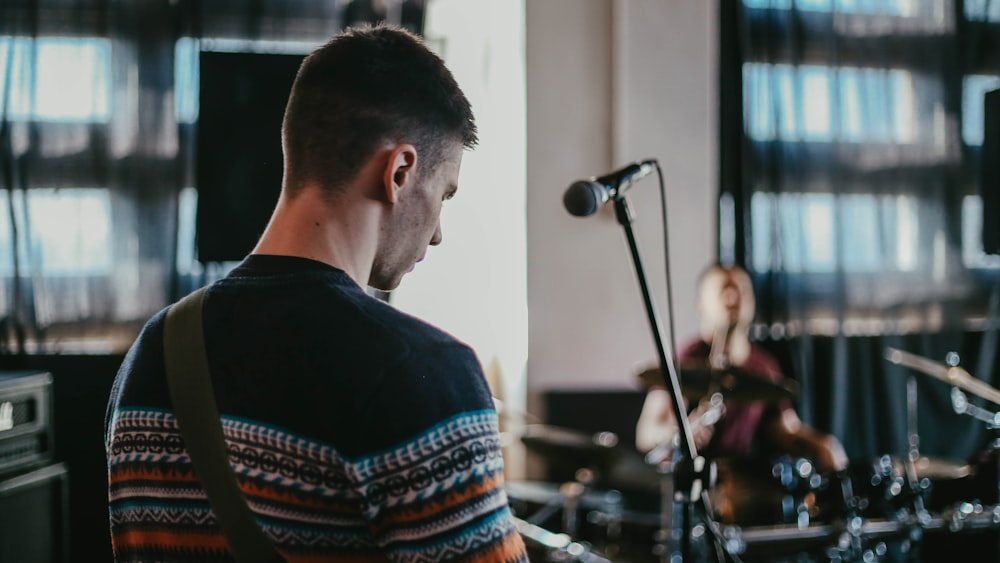 man in black crew neck shirt singing