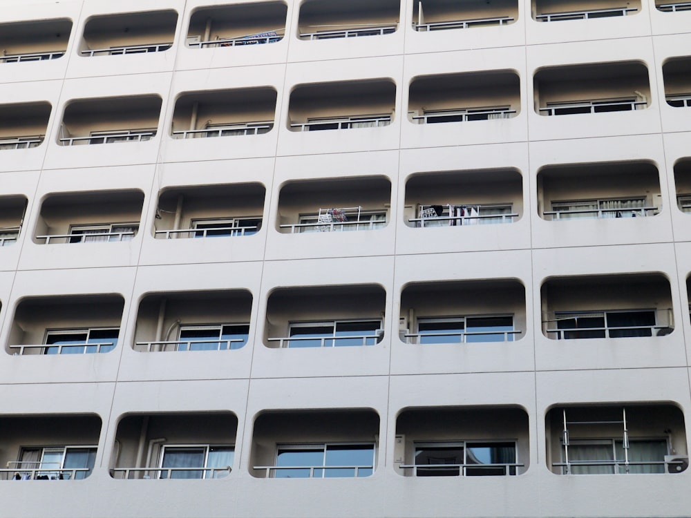 a tall white building with lots of windows