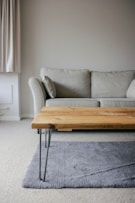 brown wooden table beside white couch