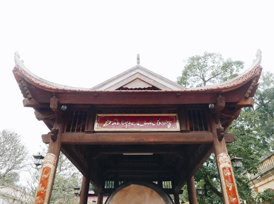 brown wooden arch under white sky during daytime in Thăng Long Imperial Citadel Vietnam