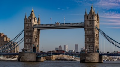 brown concrete bridge under blue sky during daytime