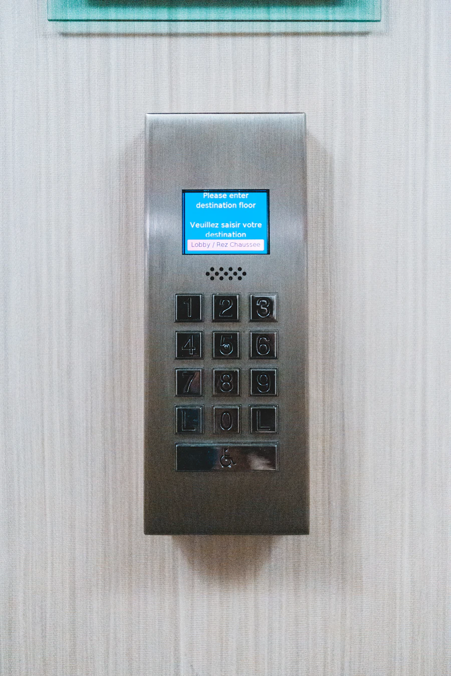 A stainless steel number keypad on a wall