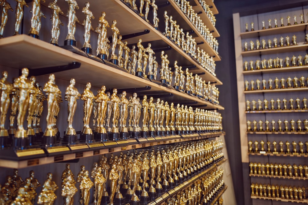 gold and silver trophy on brown wooden shelf