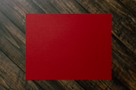 red paper on brown and gray plaid textile