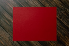 red paper on brown and gray plaid textile