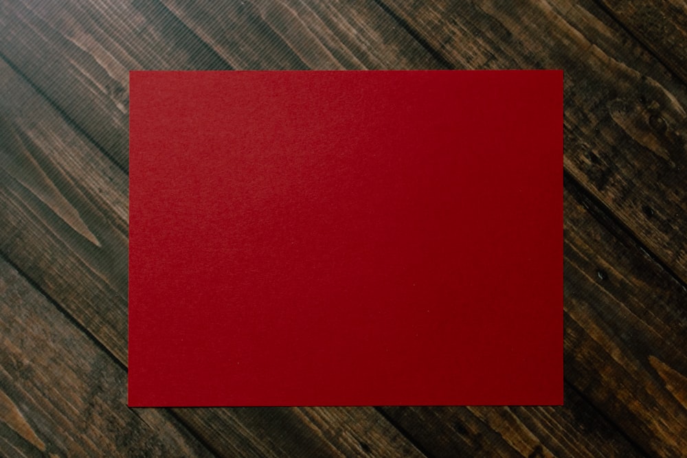 red paper on brown and gray plaid textile