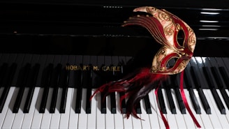 Elegant navy blue and champagne masquerade mask resting on a velvet table.