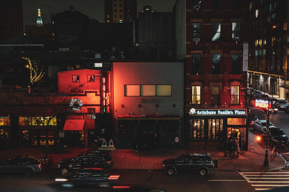 cars parked in front of building during night time