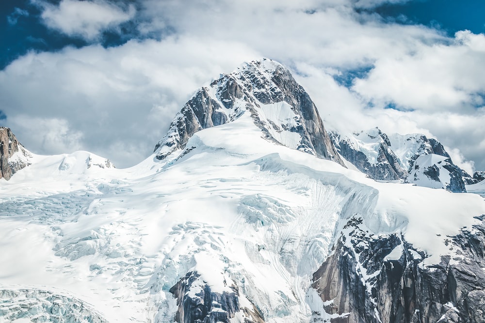 snow covered mountain under cloudy sky during daytime